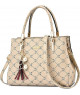 Bolso tote beige con estampado de monogramas y colgantes decorativos.